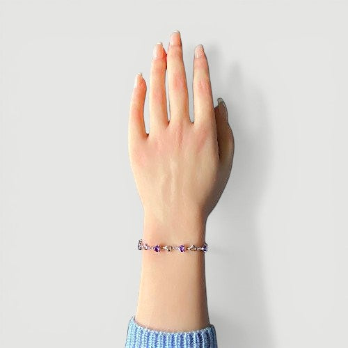 Amara Jewels sterling silver bracelet with purple heart-shaped links and shimmering stones.