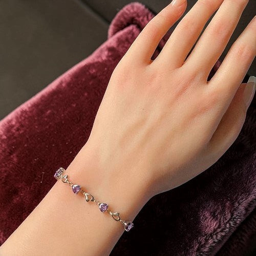 Amara Jewels sterling silver bracelet with purple heart-shaped links and shimmering stones.