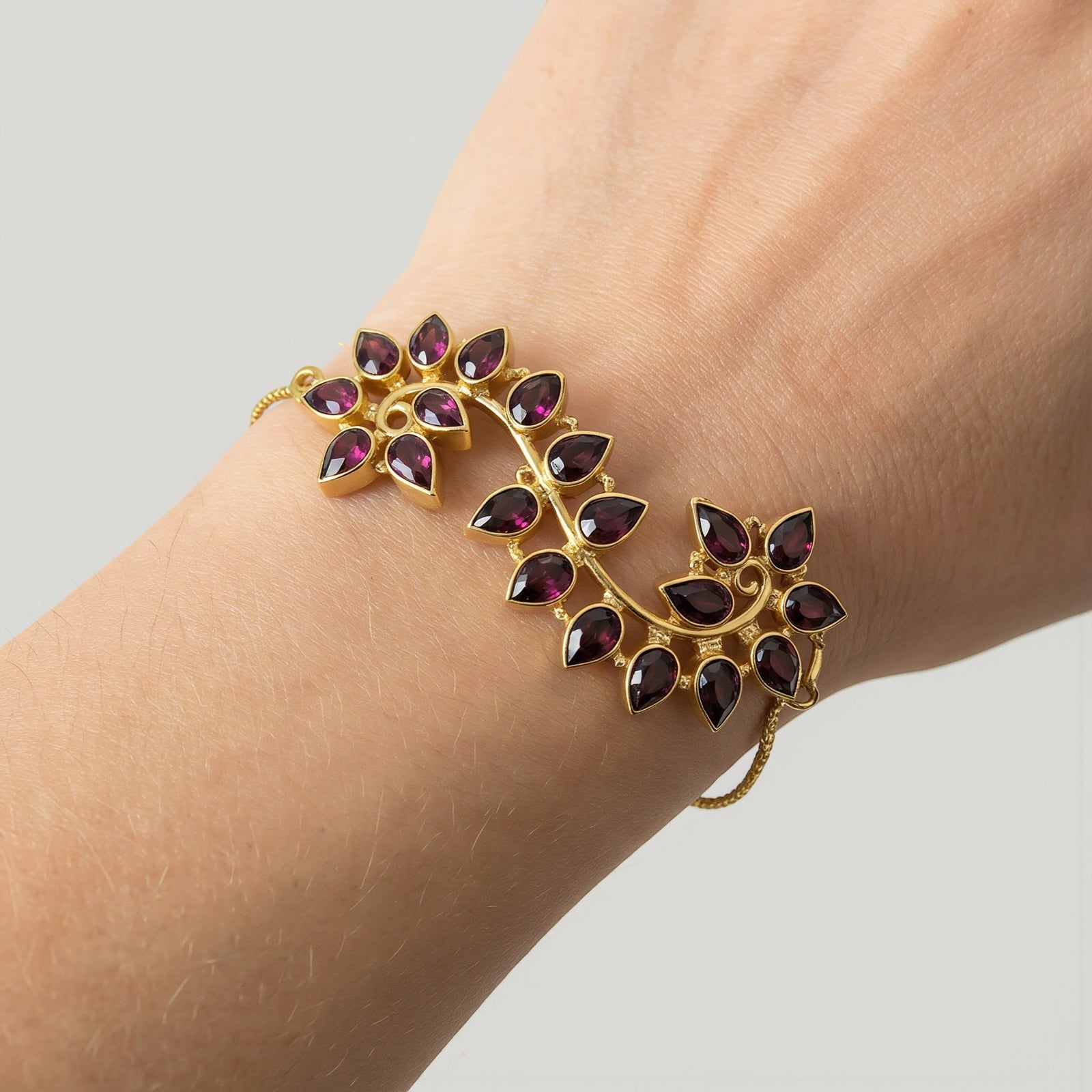 Amara Jewels Radiant Bloom Garnet Bracelet with pear-cut stones in a floral vine design, gold vermeil finish.
