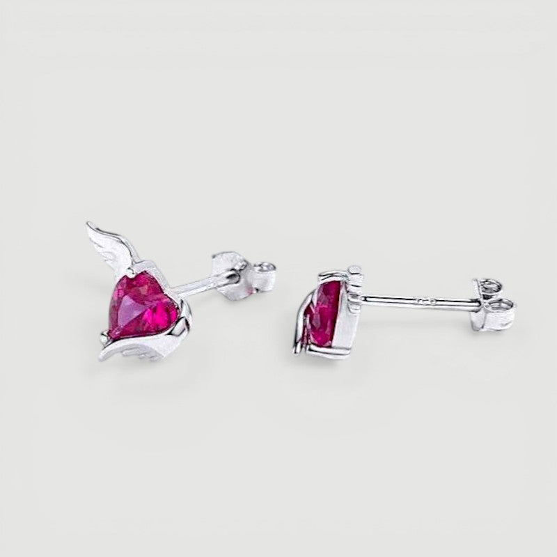 Amara Jewels sterling silver stud earrings with red heart-shaped gemstones and angel wings.