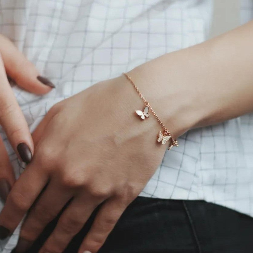Amara Jewels rose gold plated sterling silver bracelet with butterfly and star charms, adjustable length.
