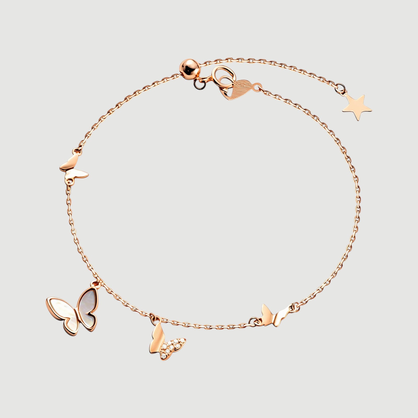 Amara Jewels rose gold plated sterling silver bracelet with butterfly and star charms, adjustable length.