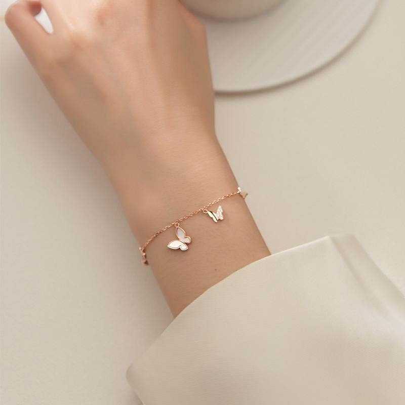 Amara Jewels rose gold plated sterling silver bracelet with butterfly and star charms, adjustable length.