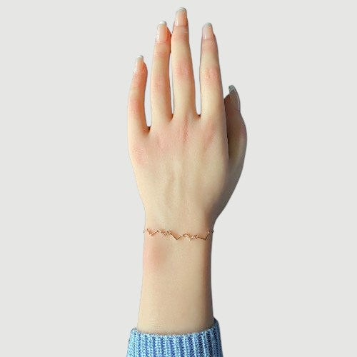 Amara Jewels rose gold chevron bracelet with zircon accents, delicate chain, minimalist design.