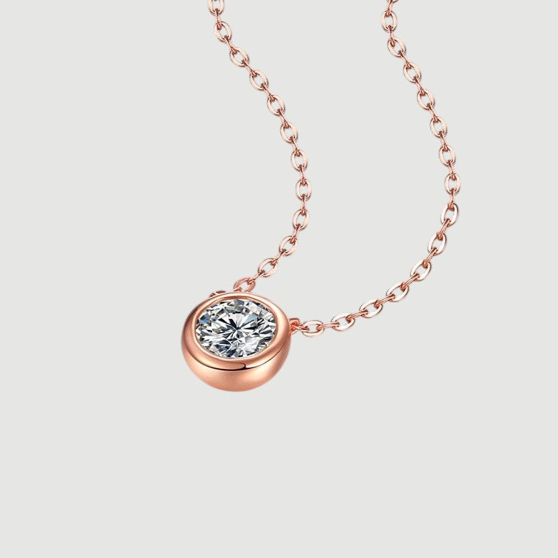 Amara Jewels rose gold 925 sterling silver necklace with a bezel-set crystal pendant.