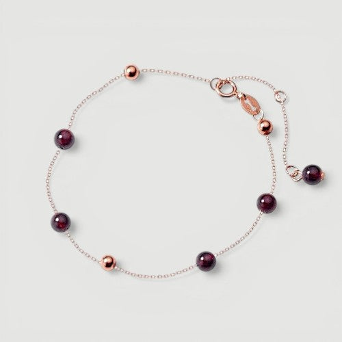 Amara Jewels rose gold plated sterling silver bracelet with garnet beads and rose gold accent beads.