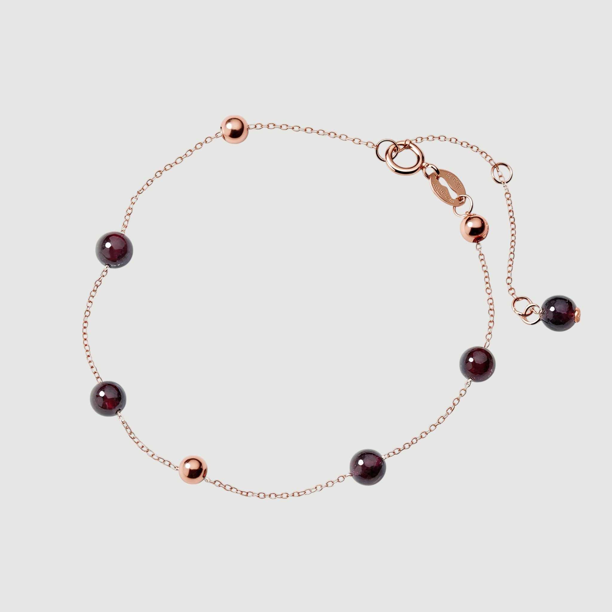 Amara Jewels rose gold plated sterling silver bracelet with garnet beads and rose gold accent beads.