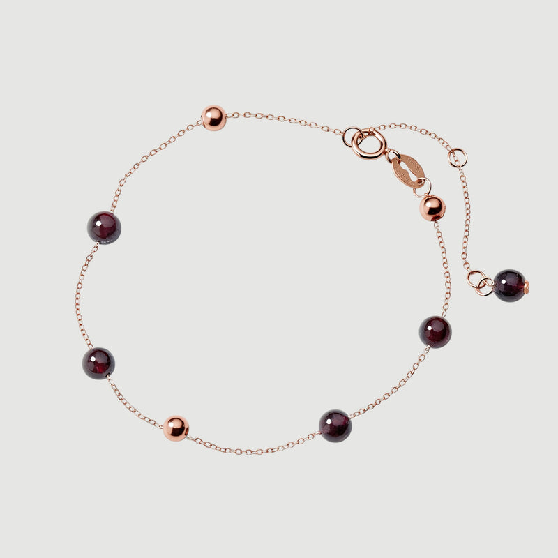 Amara Jewels rose gold plated sterling silver bracelet with garnet beads and rose gold accent beads.