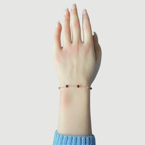 Amara Jewels rose gold plated sterling silver bracelet with garnet beads and rose gold accent beads.