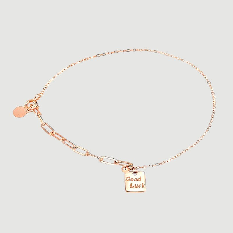 Amara Jewels rose gold plated sterling silver bracelet with a square 'Good Luck' charm and mixed chain links.