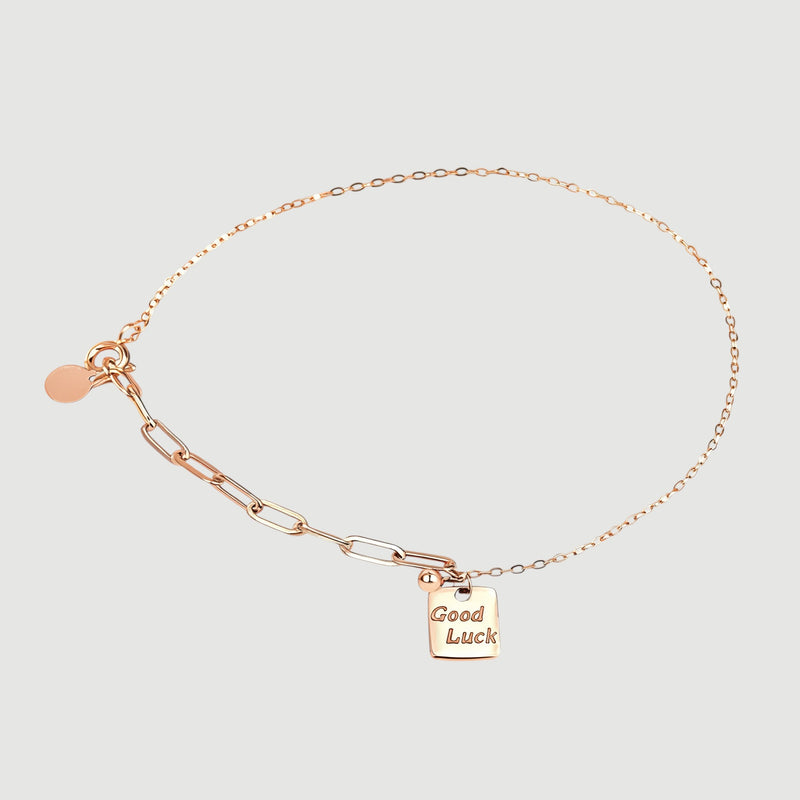Amara Jewels rose gold plated sterling silver bracelet with a square 'Good Luck' charm and mixed chain links.