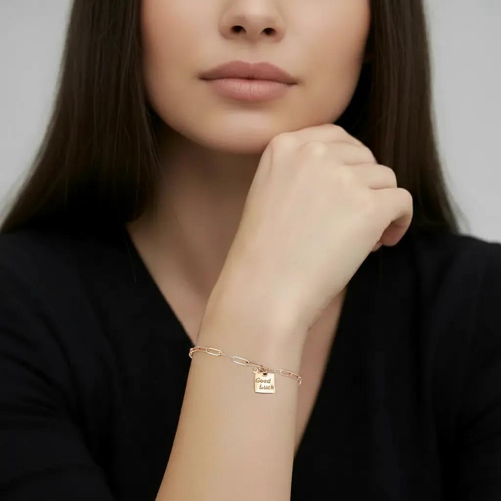 Amara Jewels rose gold plated sterling silver bracelet with a square 'Good Luck' charm and mixed chain links.