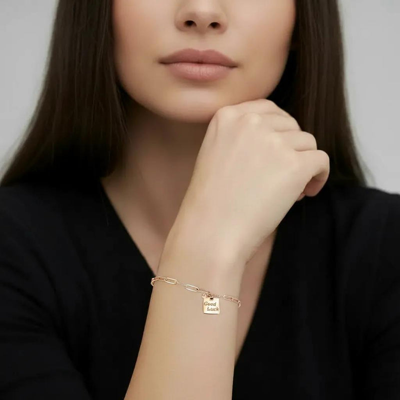 Amara Jewels rose gold plated sterling silver bracelet with a square 'Good Luck' charm and mixed chain links.
