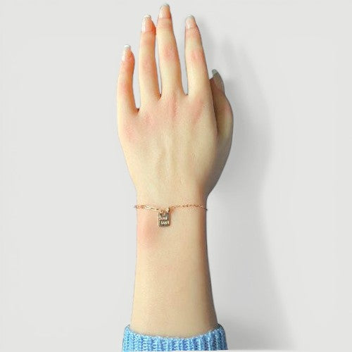 Amara Jewels rose gold plated sterling silver bracelet with a square 'Good Luck' charm and mixed chain links.