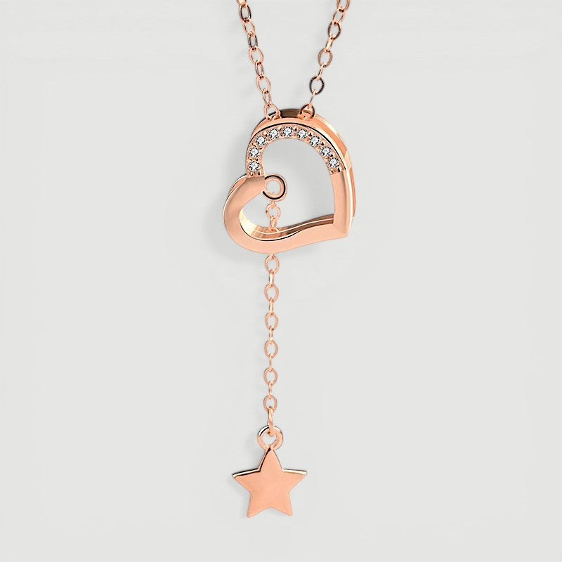 Amara Jewels rose gold tone necklace with heart pendant adorned with cubic zirconia and a dangling star charm.