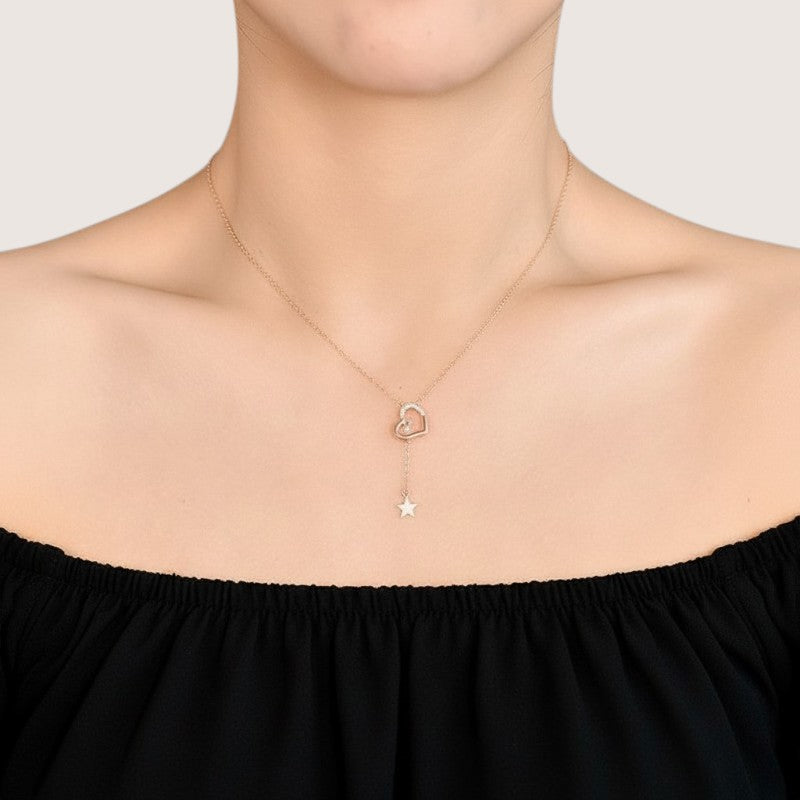 Amara Jewels rose gold tone necklace with a heart pendant adorned with cubic zirconia and a dangling star charm.