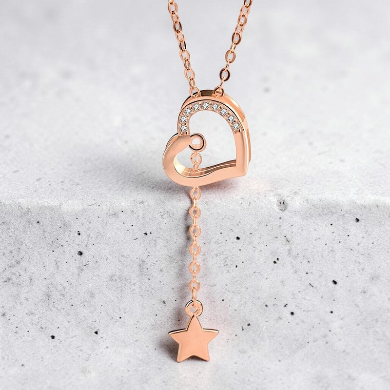 Amara Jewels rose gold tone necklace with a heart pendant adorned with cubic zirconia and a dangling star charm.
