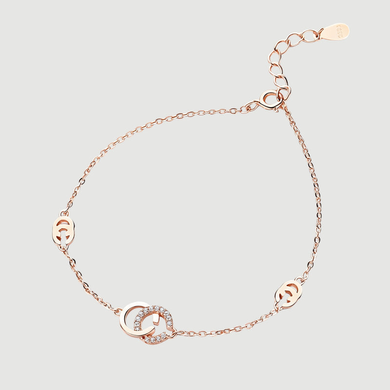 Amara Jewels rose gold 925 sterling silver adjustable chain bracelet with interlocking circles, one adorned with cubic zirconia.