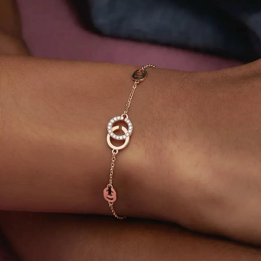 Amara Jewels rose gold 925 sterling silver adjustable chain bracelet with interlocking circles, one adorned with cubic zirconia.