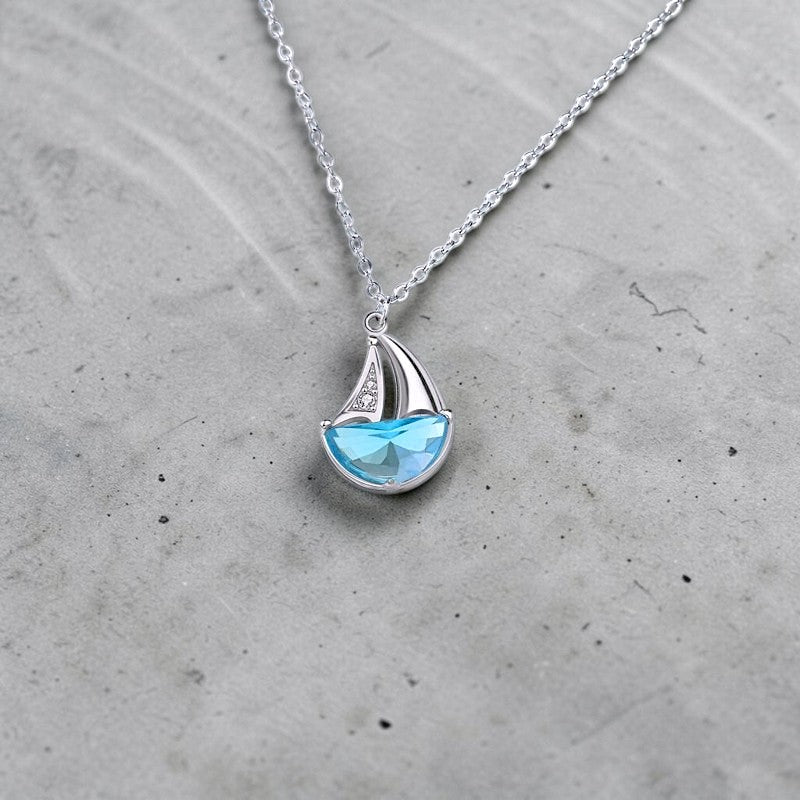 Amara Jewels 925 sterling silver sailboat necklace with blue crystal and cubic zirconia accents.