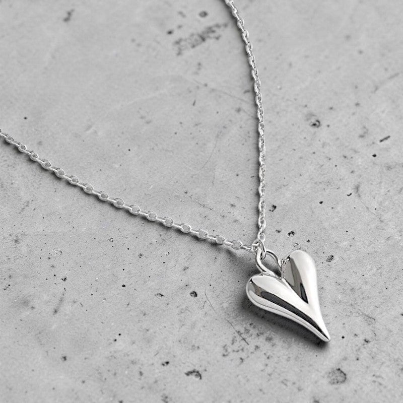Amara Jewels sculpted heart pendant necklace in polished sterling silver with a delicate chain.