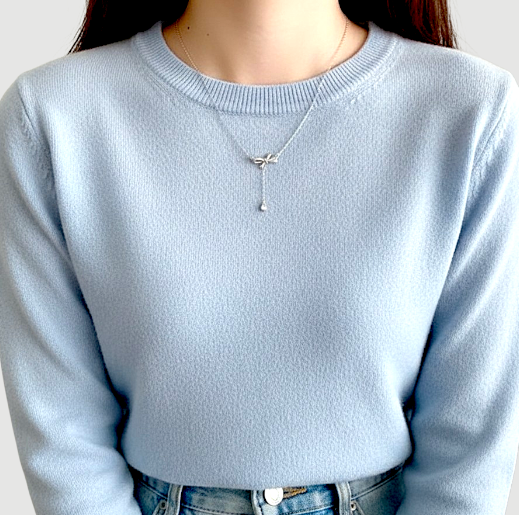 Amara Jewels sterling silver bow pendant necklace with cubic zirconia accents and a dangling pear-shaped stone.