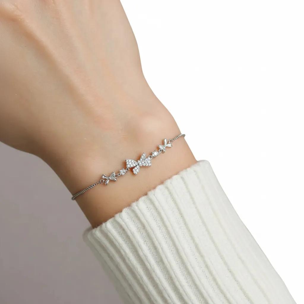 Amara Jewels 925 sterling silver adjustable bracelet with butterfly and floral charms, adorned with sparkling cubic zirconia.