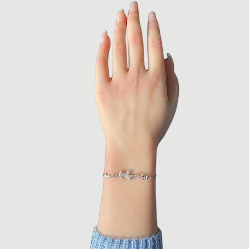 Amara Jewels 925 sterling silver adjustable bracelet with butterfly and floral charms, adorned with sparkling cubic zirconia.