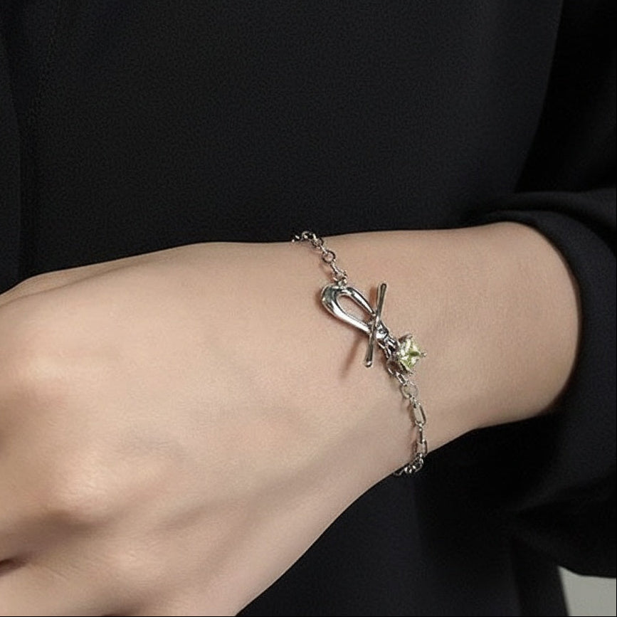 Amara Jewels sterling silver bracelet with paperclip chain, T-bar clasp, and a square citrine-colored charm.