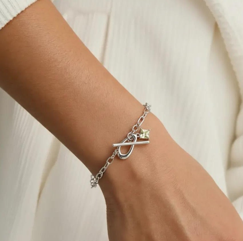 Amara Jewels sterling silver bracelet with paperclip chain, T-bar clasp, and a square citrine-colored charm.
