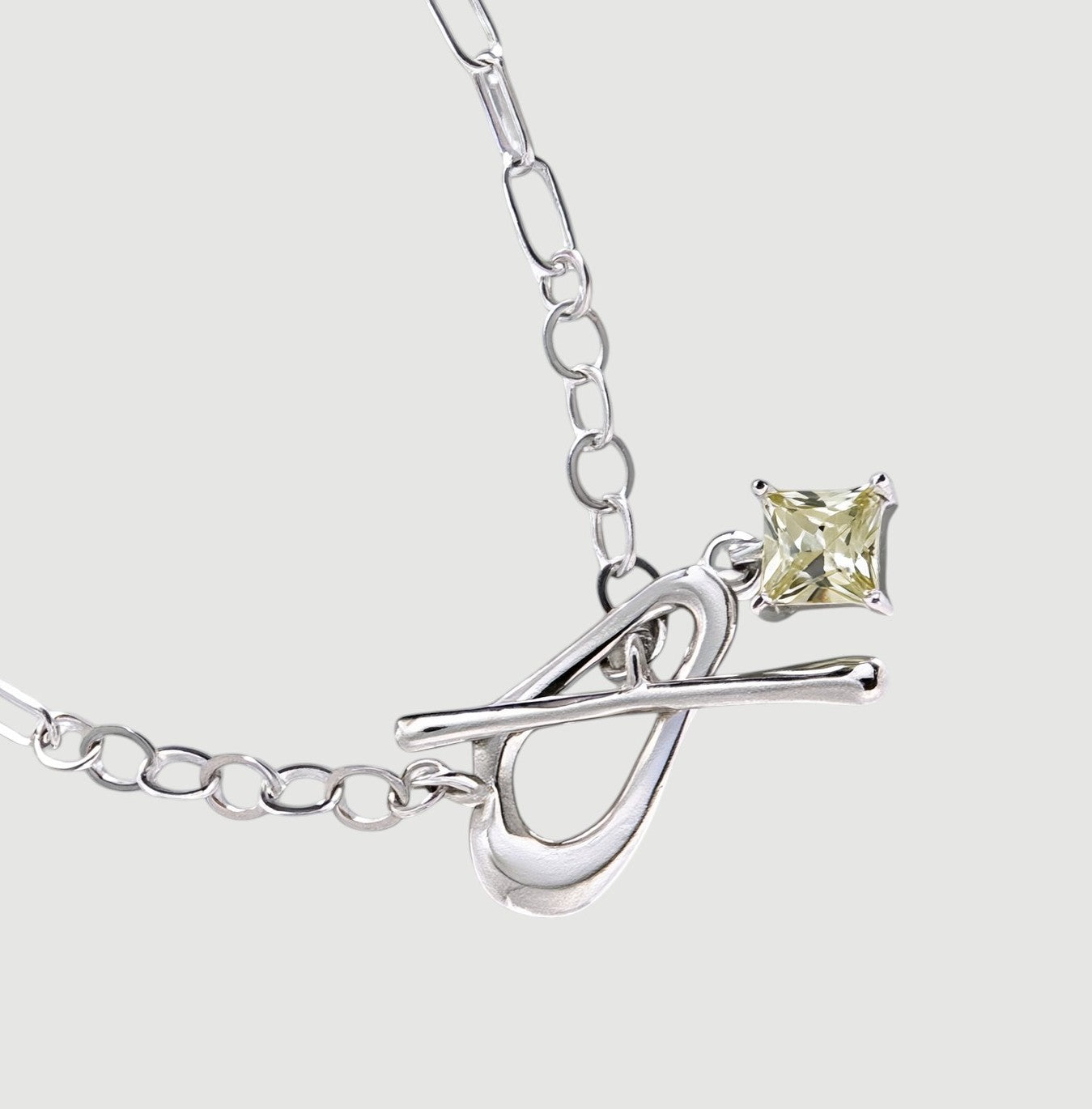 Amara Jewels sterling silver bracelet with paperclip chain, T-bar clasp, and a square citrine-colored charm.
