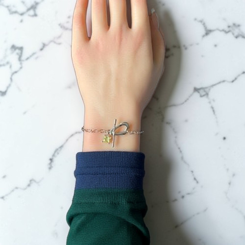 Amara Jewels sterling silver bracelet with paperclip chain, T-bar clasp, and a square citrine-colored charm.