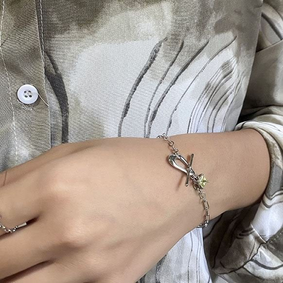 Amara Jewels sterling silver bracelet with paperclip chain, T-bar clasp, and a square citrine-colored charm.