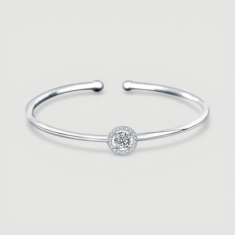 Amara Jewels 925 sterling silver bangle with a sparkling crystal centerpiece, perfect for adding elegance to any outfit.