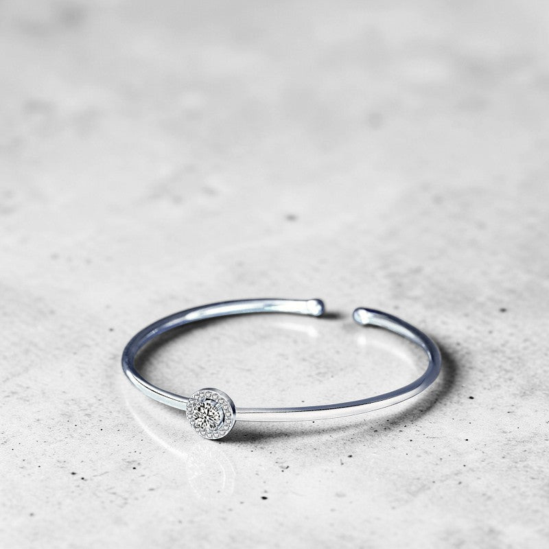 Amara Jewels 925 sterling silver bangle with a sparkling crystal centerpiece, perfect for adding elegance to any outfit.