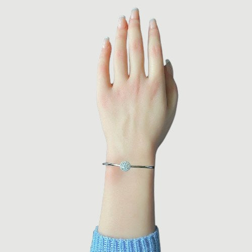 Amara Jewels 925 sterling silver bangle with a sparkling crystal centerpiece, perfect for adding elegance to any outfit.