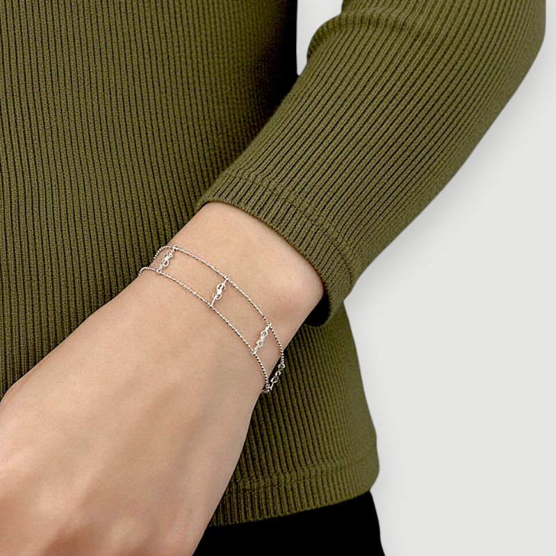 Amara Jewels 925 Sterling Silver double chain bracelet with dollar sign charms and bead detailing.