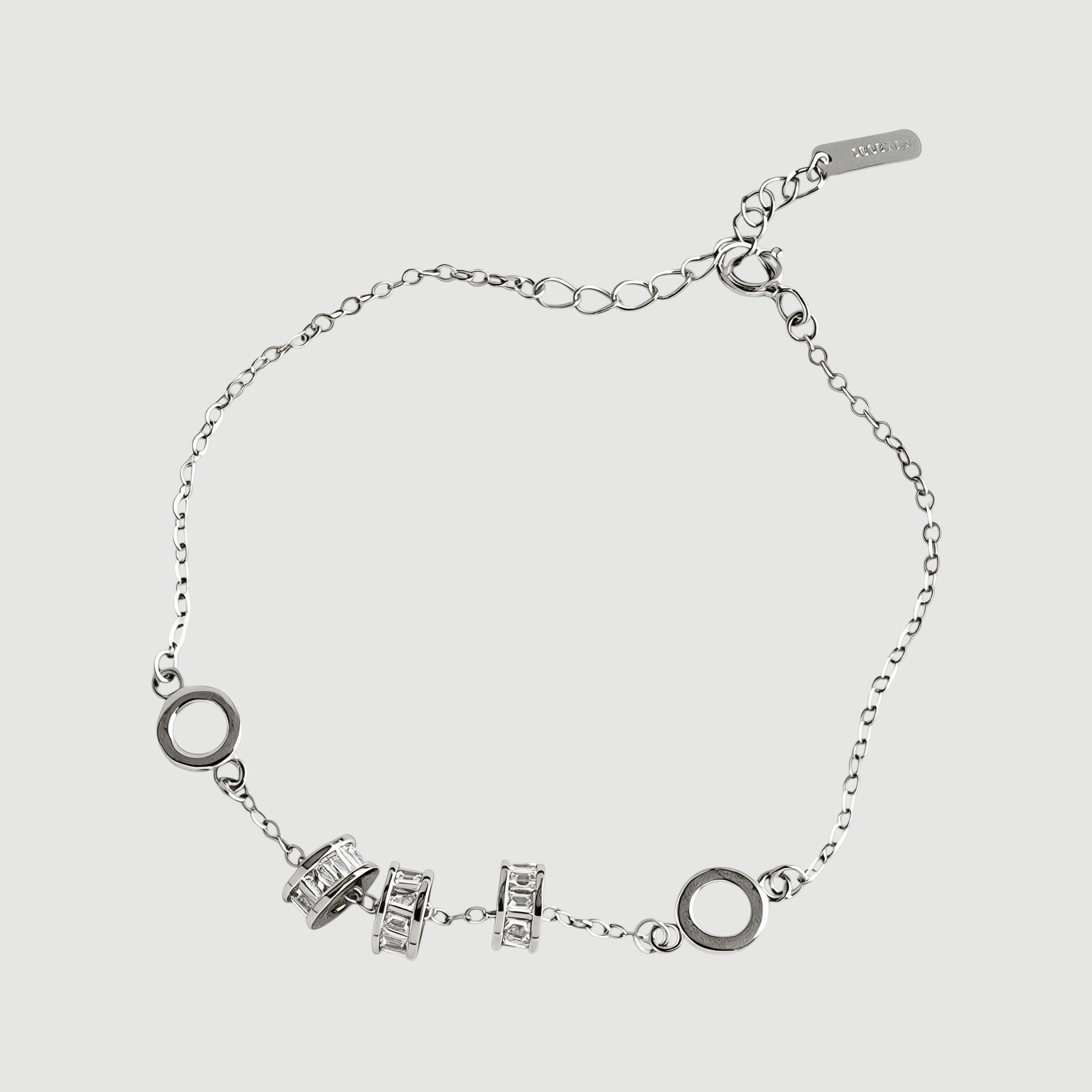 Amara Jewels 925 sterling silver bracelet with geometric charms and adjustable chain. Features circular and bar charms with baguette-cut stones.
