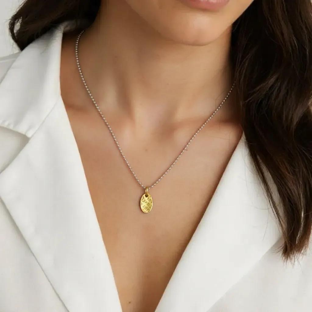 Amara Jewels sterling silver ball chain necklace with textured gold oval pendant embossed with 'LOVE'.