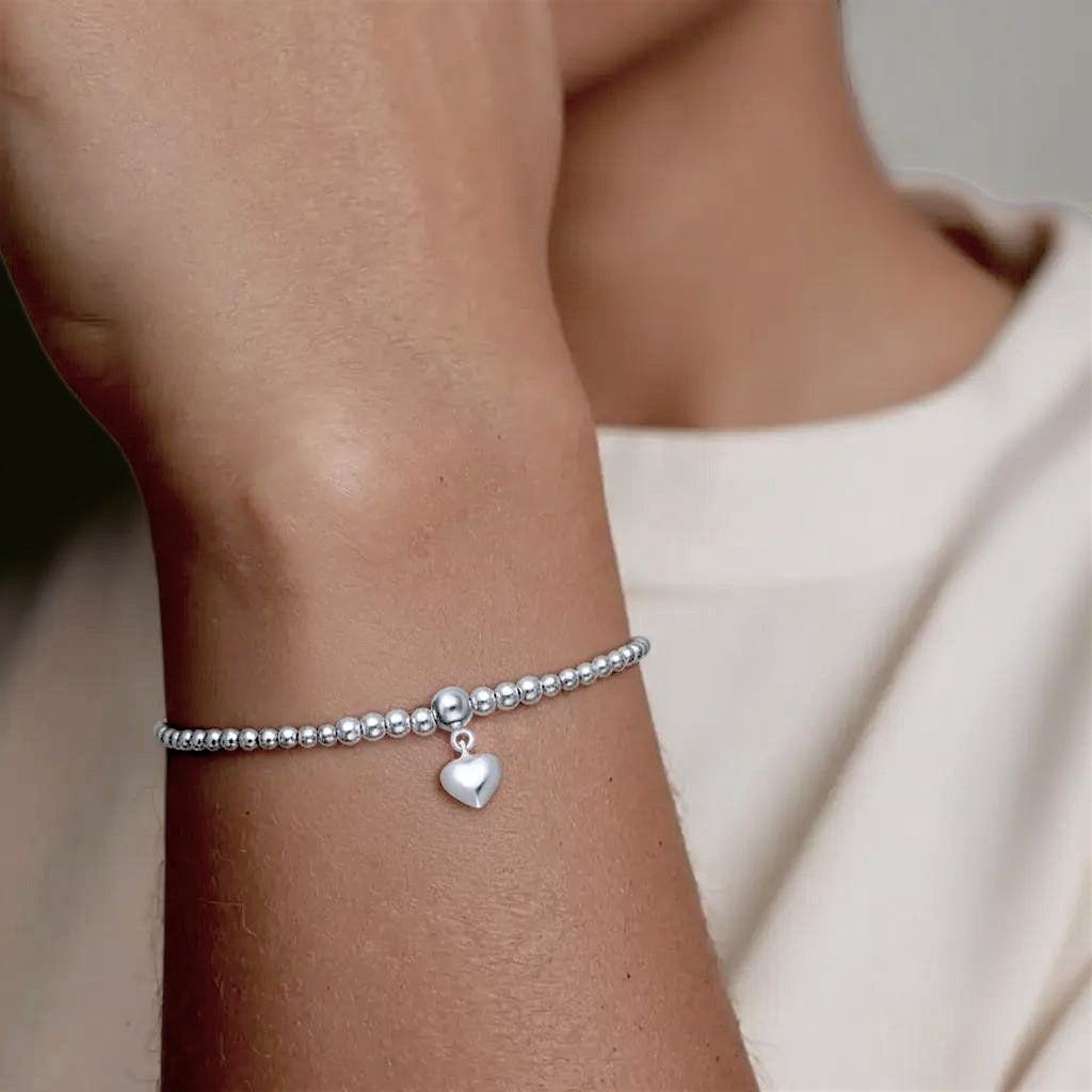 Amara Jewels sterling silver beaded bracelet with a dangling heart charm and adjustable sliding closure.