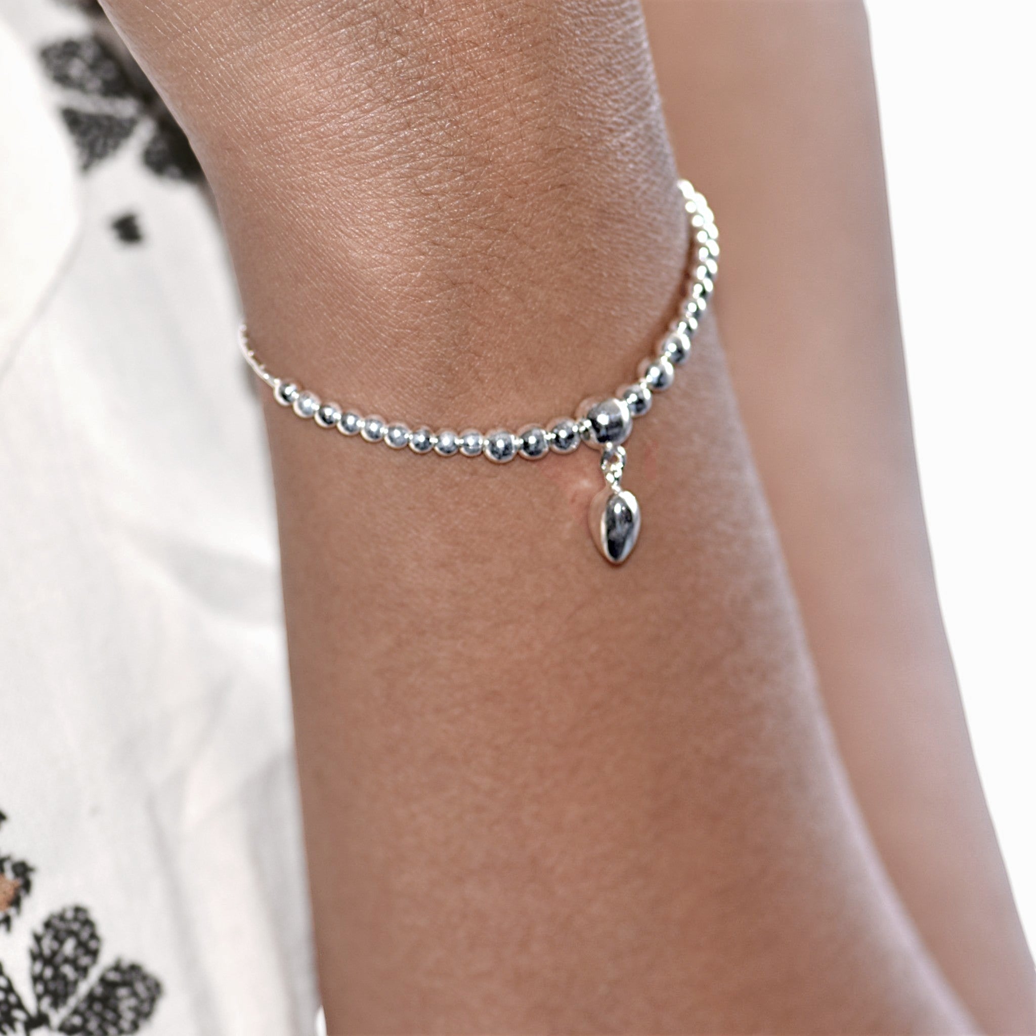 Amara Jewels sterling silver beaded bracelet with a dangling heart charm and adjustable sliding closure.