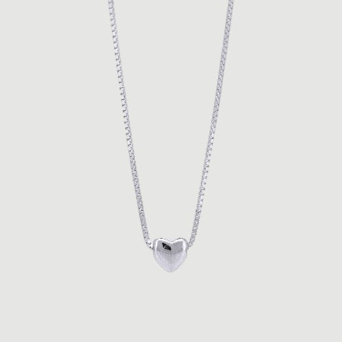 Amara Jewels minimalist sterling silver heart necklace with a delicate box chain. Polished silver pendant.