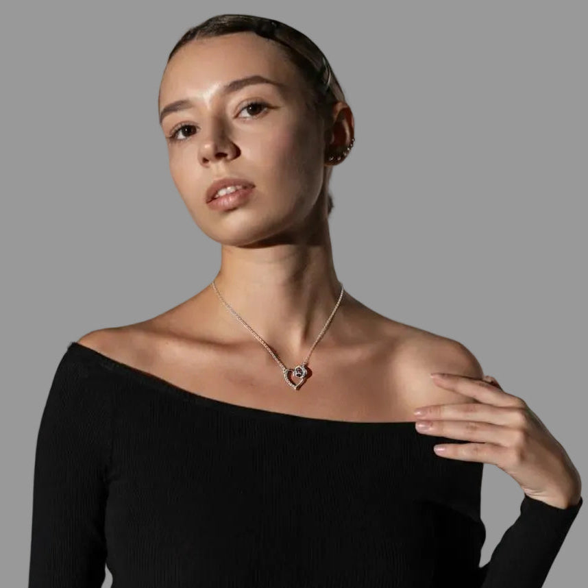 Amara Jewels silver 925 sterling necklace with a delicate heart pendant featuring crystal accents and an intertwined ring detail.