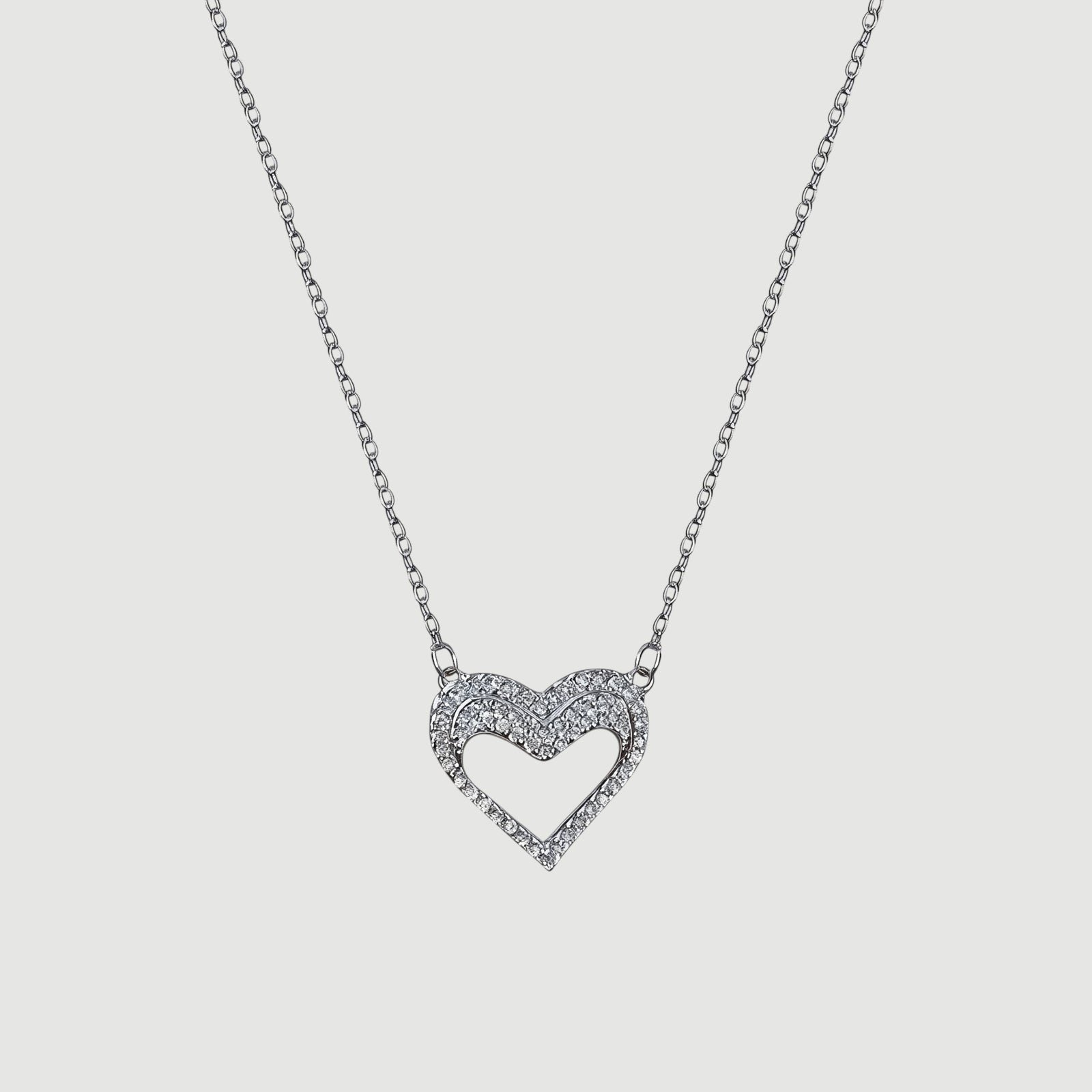 Amara Jewels silver hollow heart necklace with crystal embellishments, delicate chain.