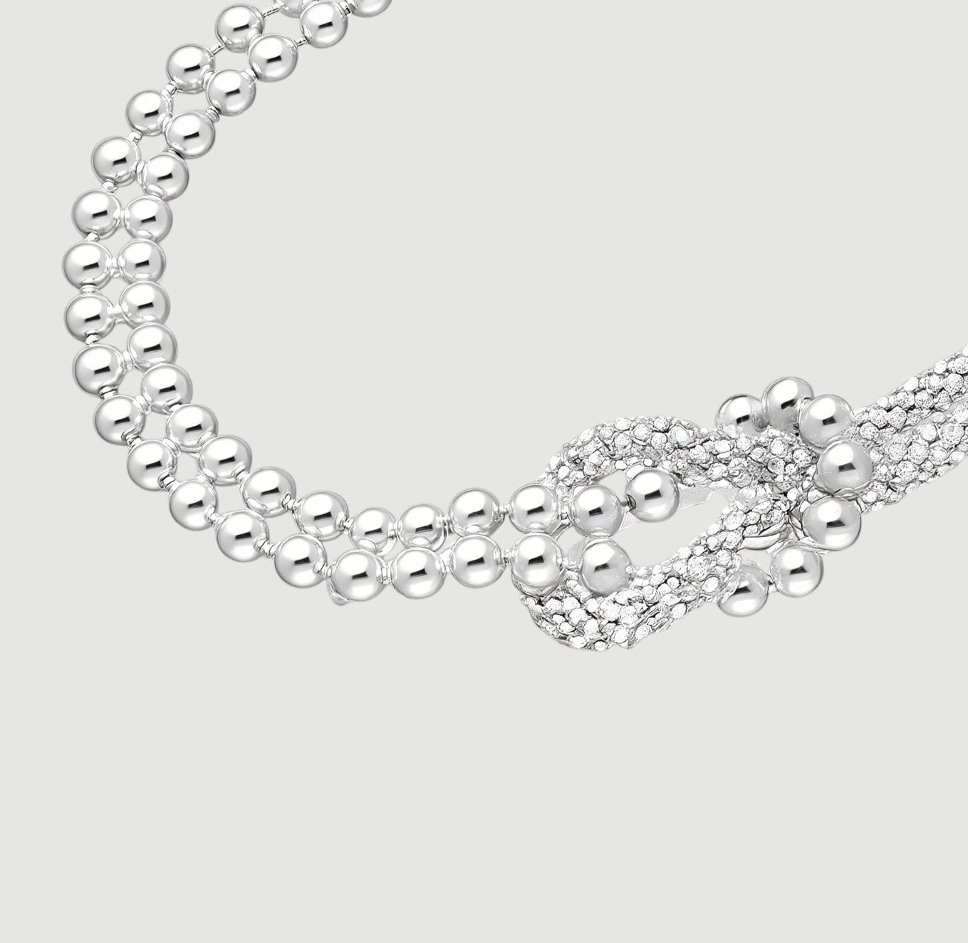 Amara Jewels sterling silver bracelet with multi-strand design and knot centerpiece, featuring polished silver beads.