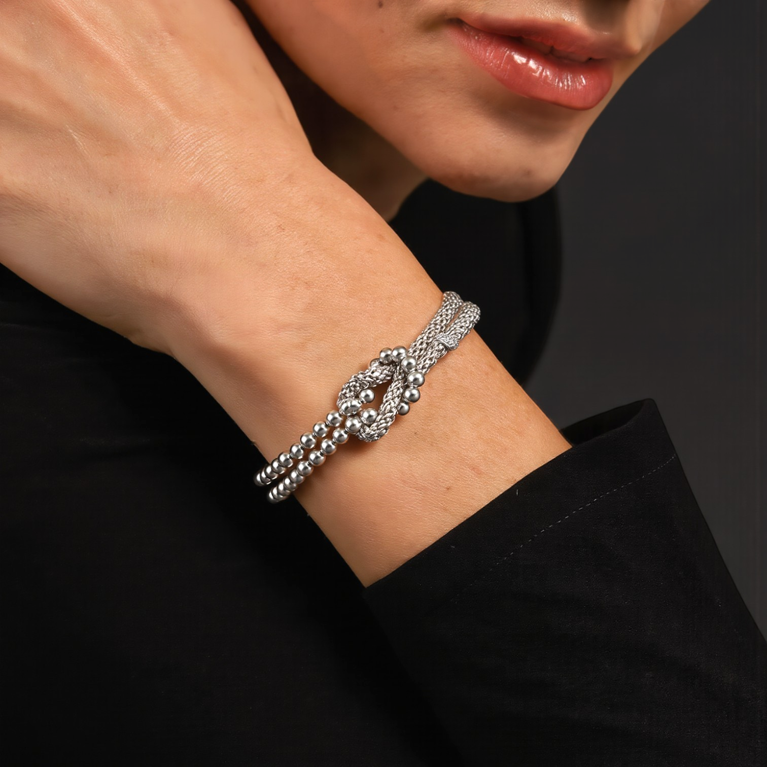 Amara Jewels sterling silver bracelet with multi-strand design and knot centerpiece, featuring polished silver beads.