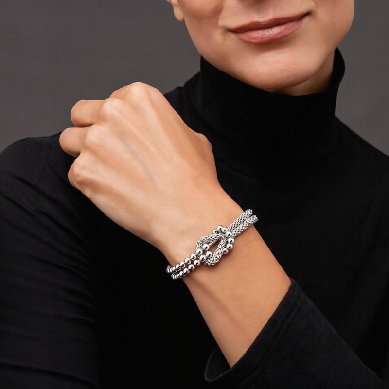 Amara Jewels sterling silver bracelet with multi-strand design and knot centerpiece, featuring polished silver beads.