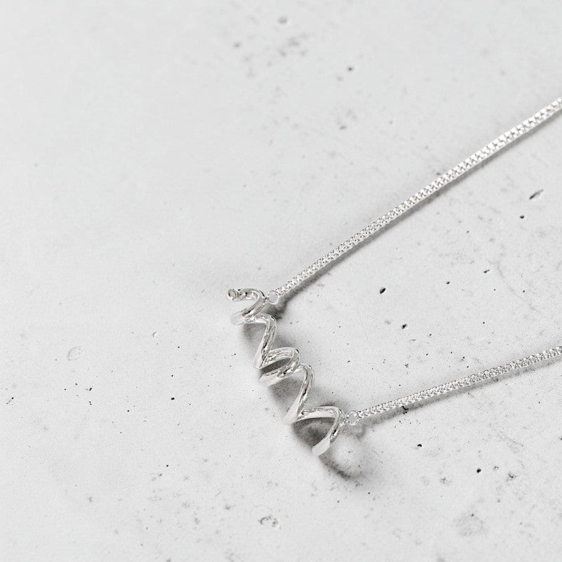 Amara Jewels sterling silver spiral twist necklace with polished finish and contemporary coiled design.