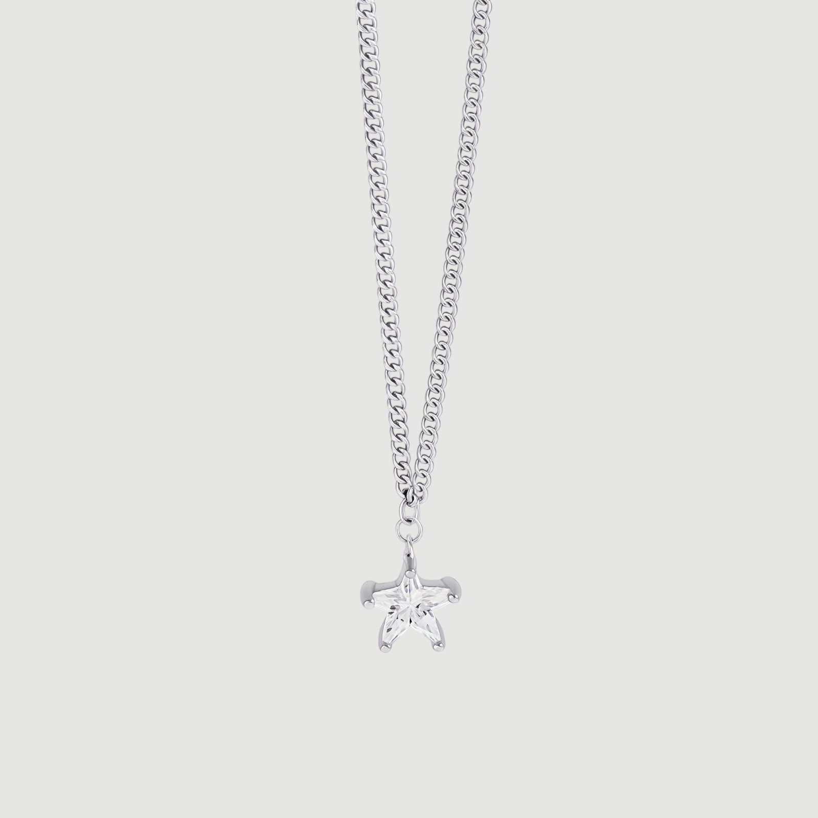 Amara Jewels silver 925 sterling silver necklace with a small, clear star pendant and a curb chain.