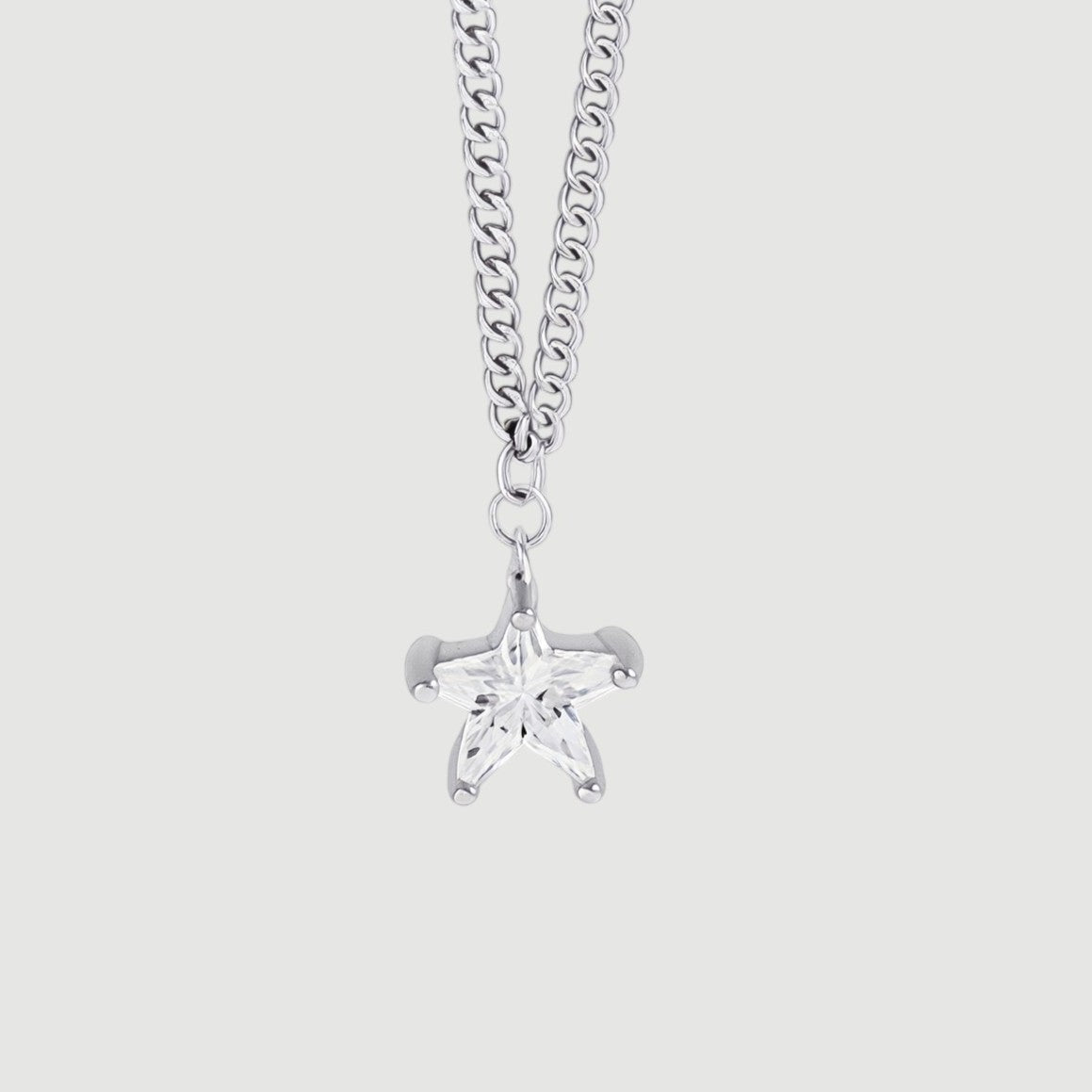 Amara Jewels silver 925 sterling silver necklace with a small, clear star pendant and a curb chain.